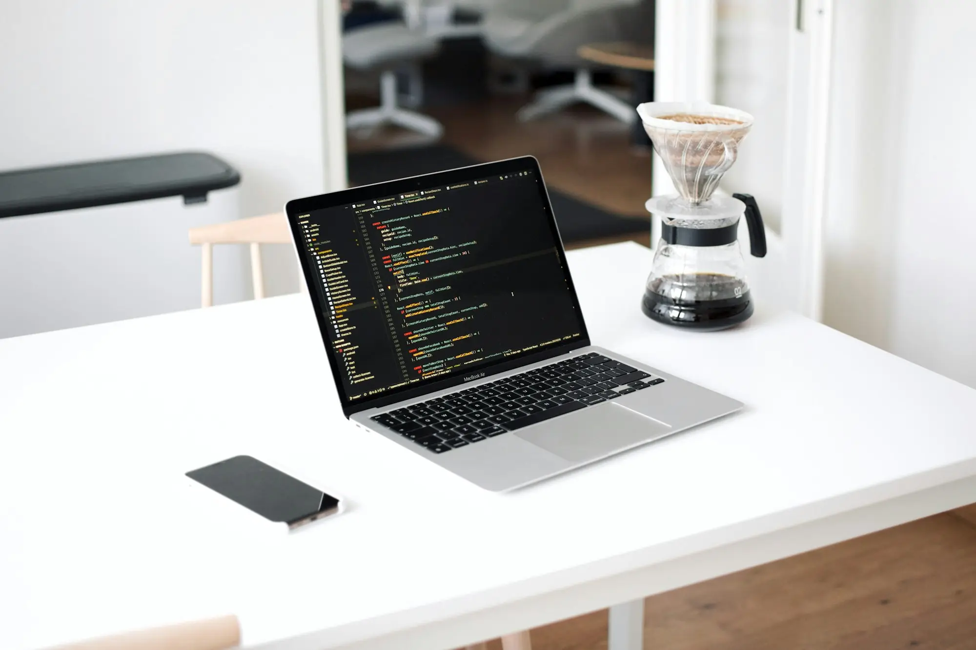 Laptop and phone on a clean desk for cash flow planning