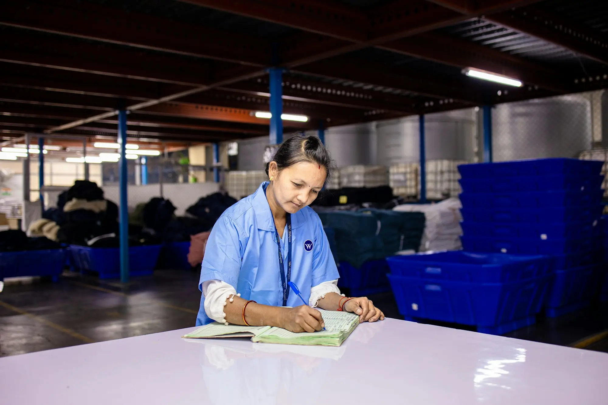 Importer checking stock paperwork at a warehouse bench